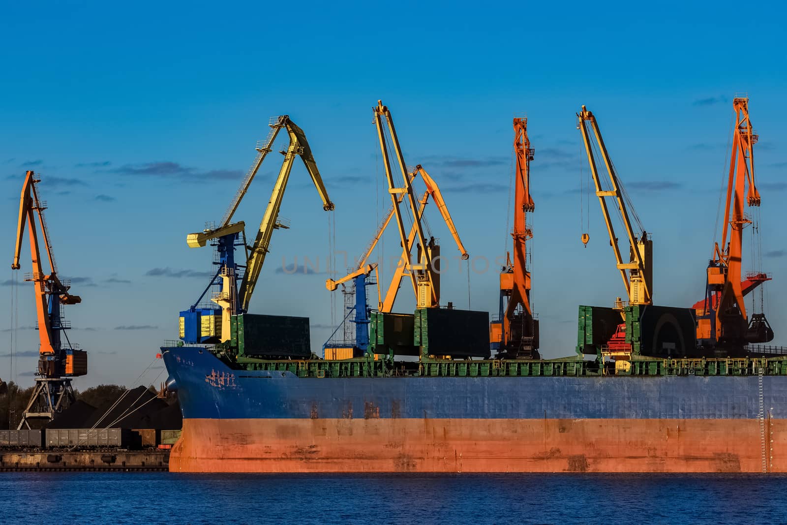 Blue cargo ship loading in the port of Riga, Europe