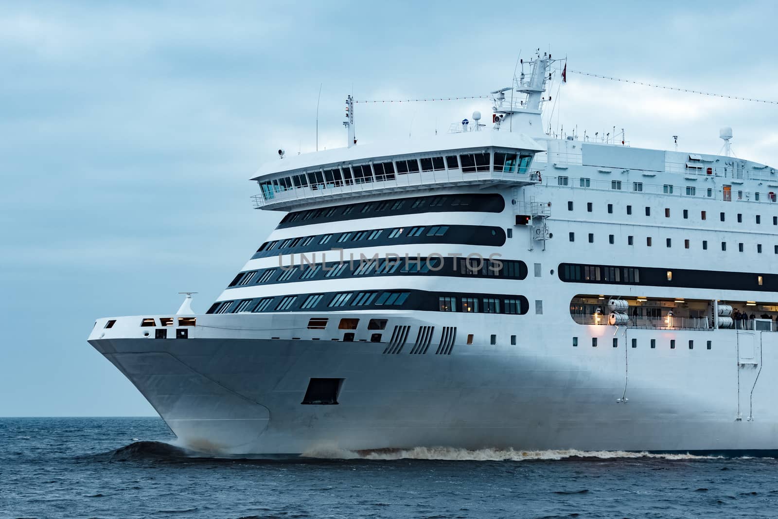 White cruise liner. Passenger ferry moving in still water