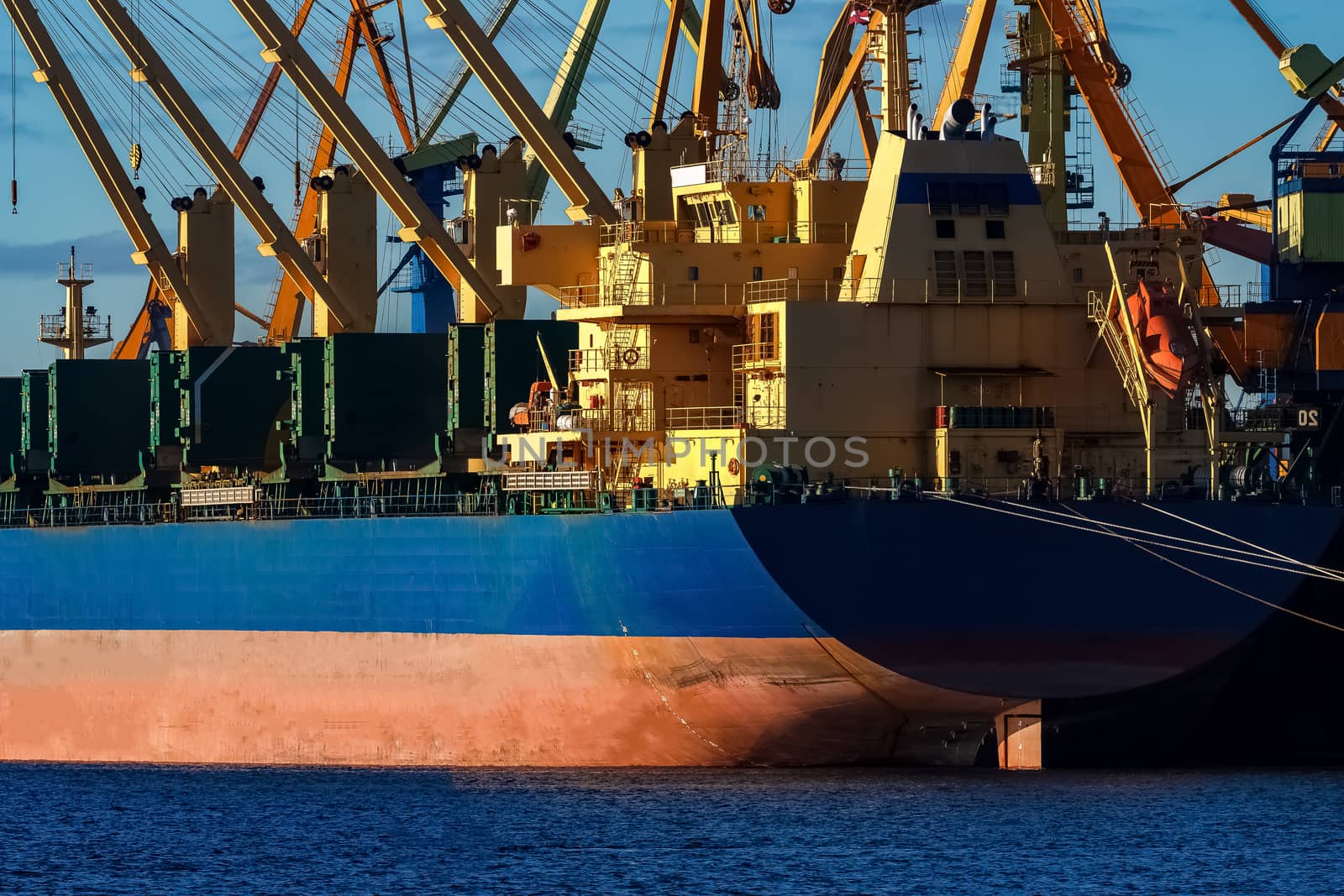 Blue cargo ship loading in the port of Riga, Europe