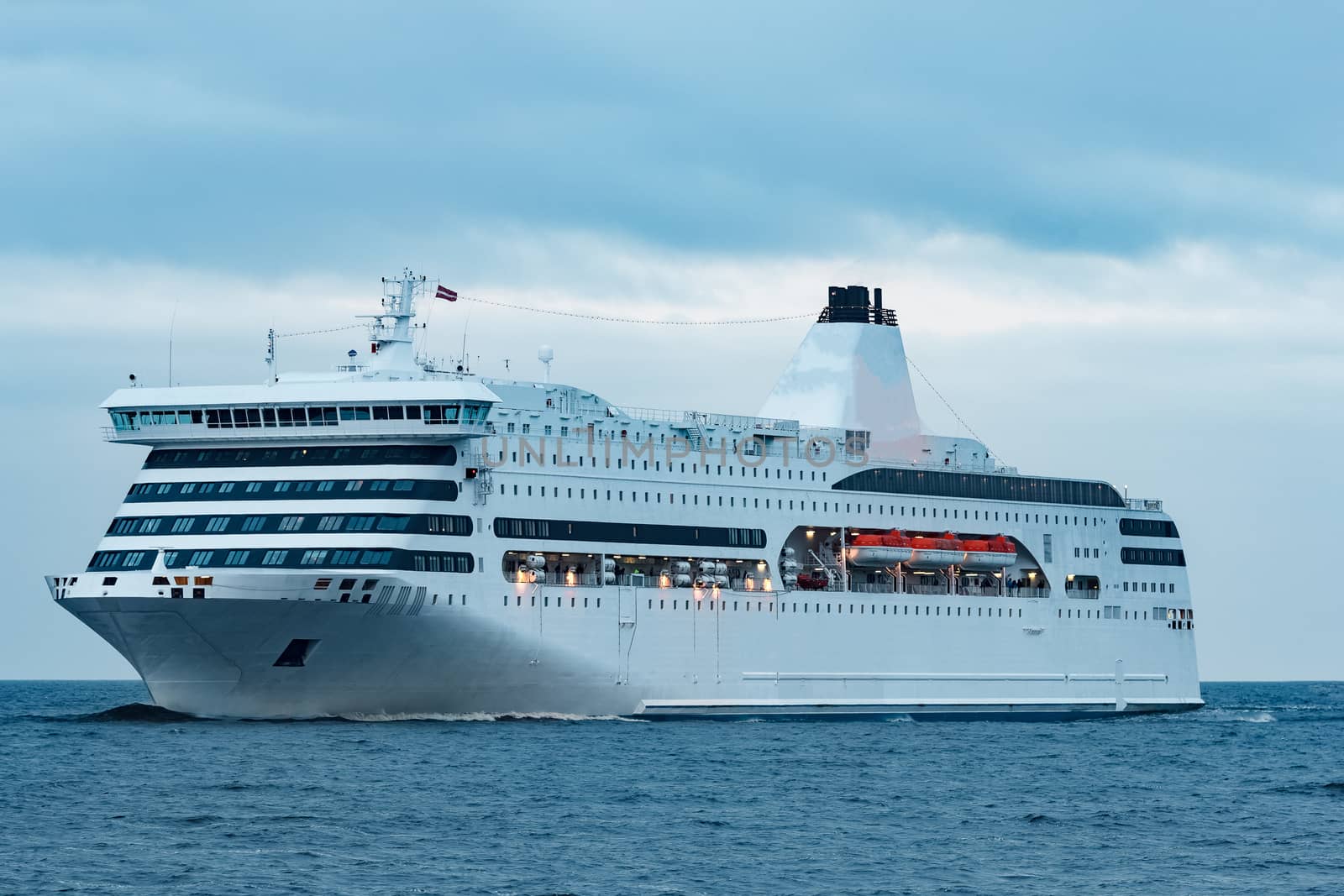 White cruise liner. Passenger ferry moving in still water