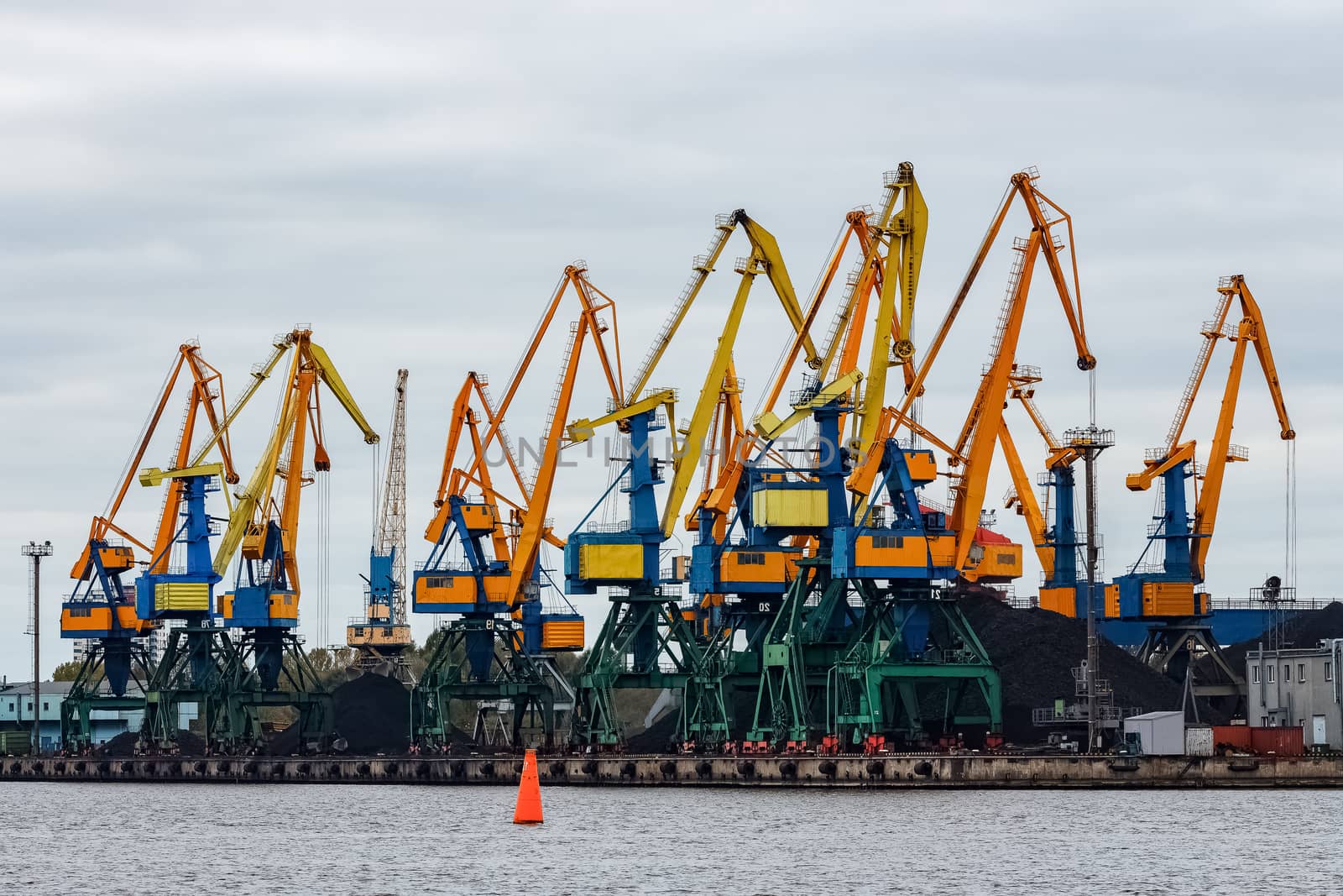 Yellow cargo cranes in the port of Riga, Europe