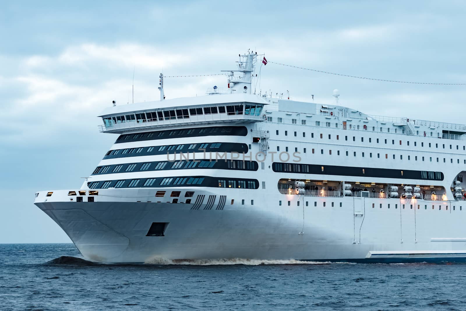White cruise liner. Passenger ferry moving in still water