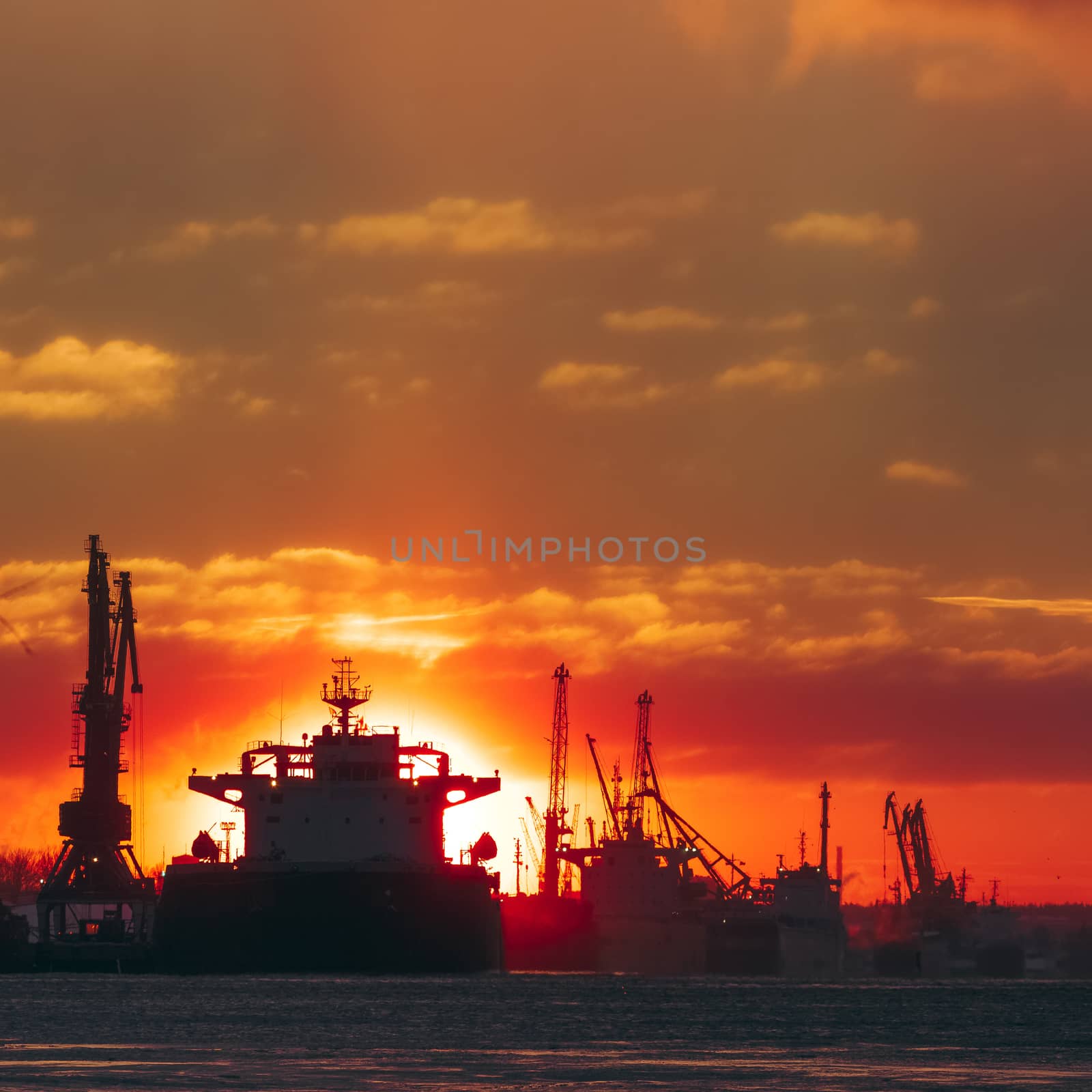 Colorful winter sunrise against the cargo port