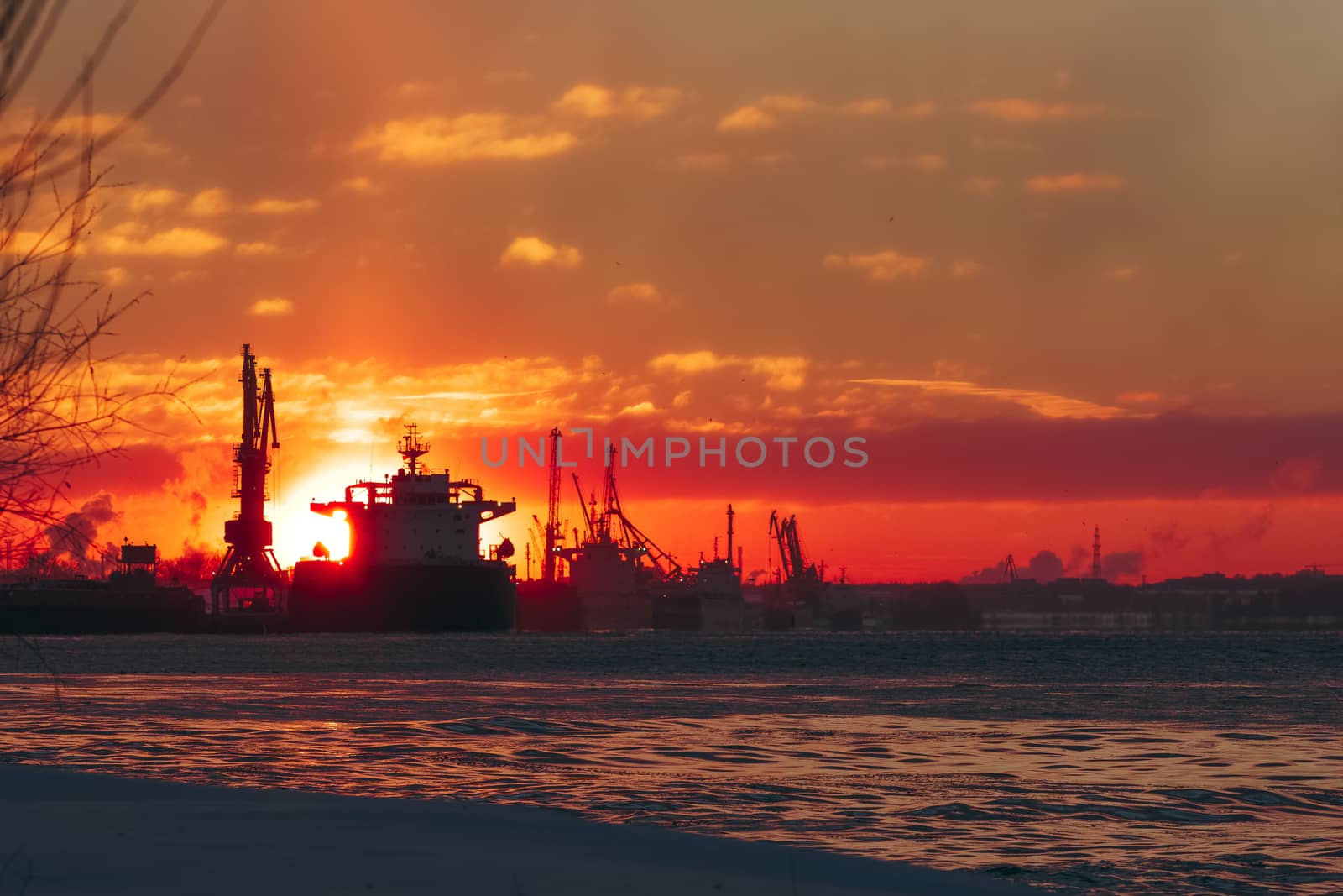 Colorful winter sunrise against the cargo port