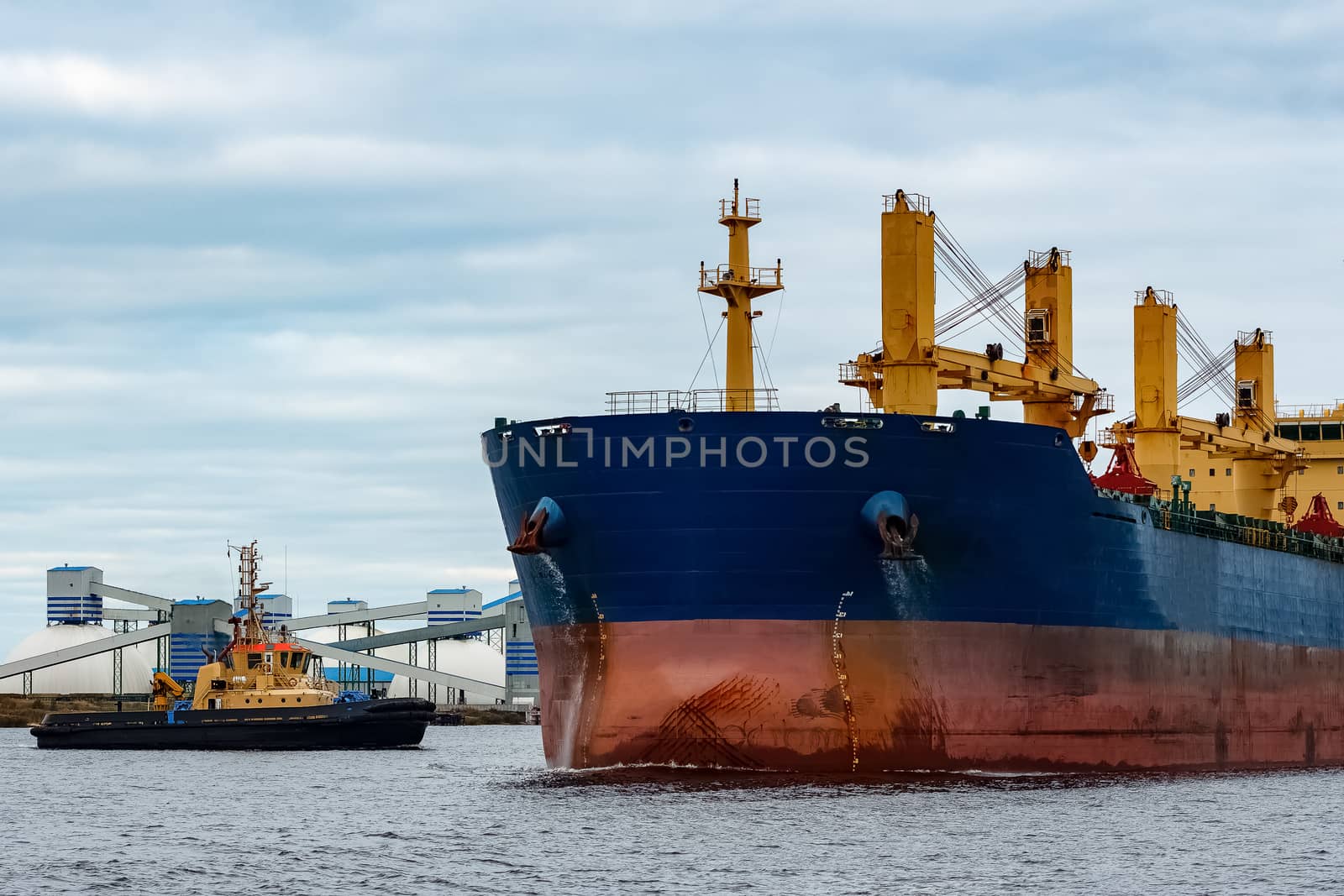 Blue cargo ship entering the port of Riga, Europe