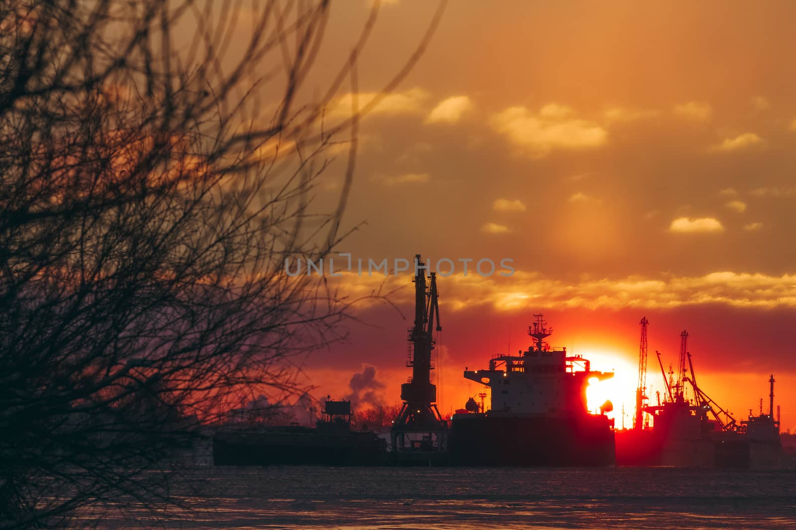 Colorful winter sunrise against the cargo port