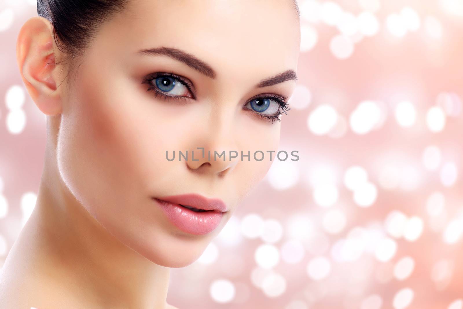 Closeup shot of beautiful female face against an abstract background with blurred lights