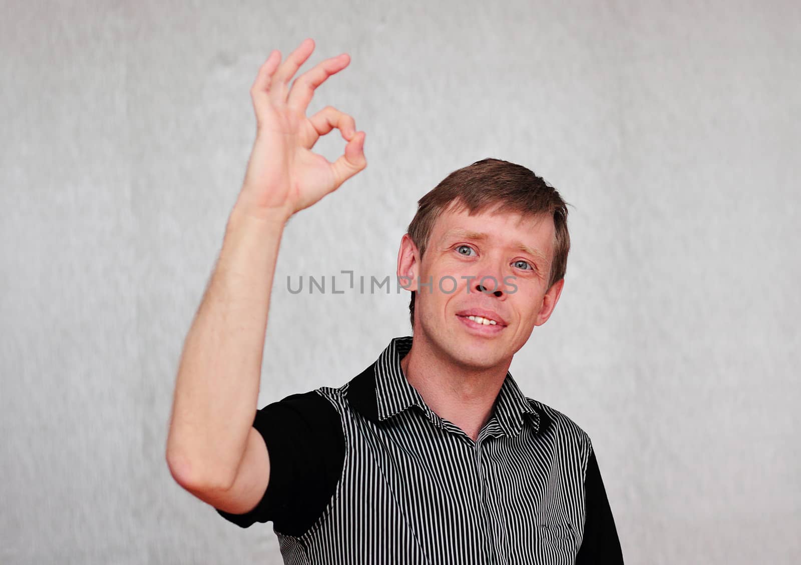 Gesture attractive middle aged man isolated on neutral background.