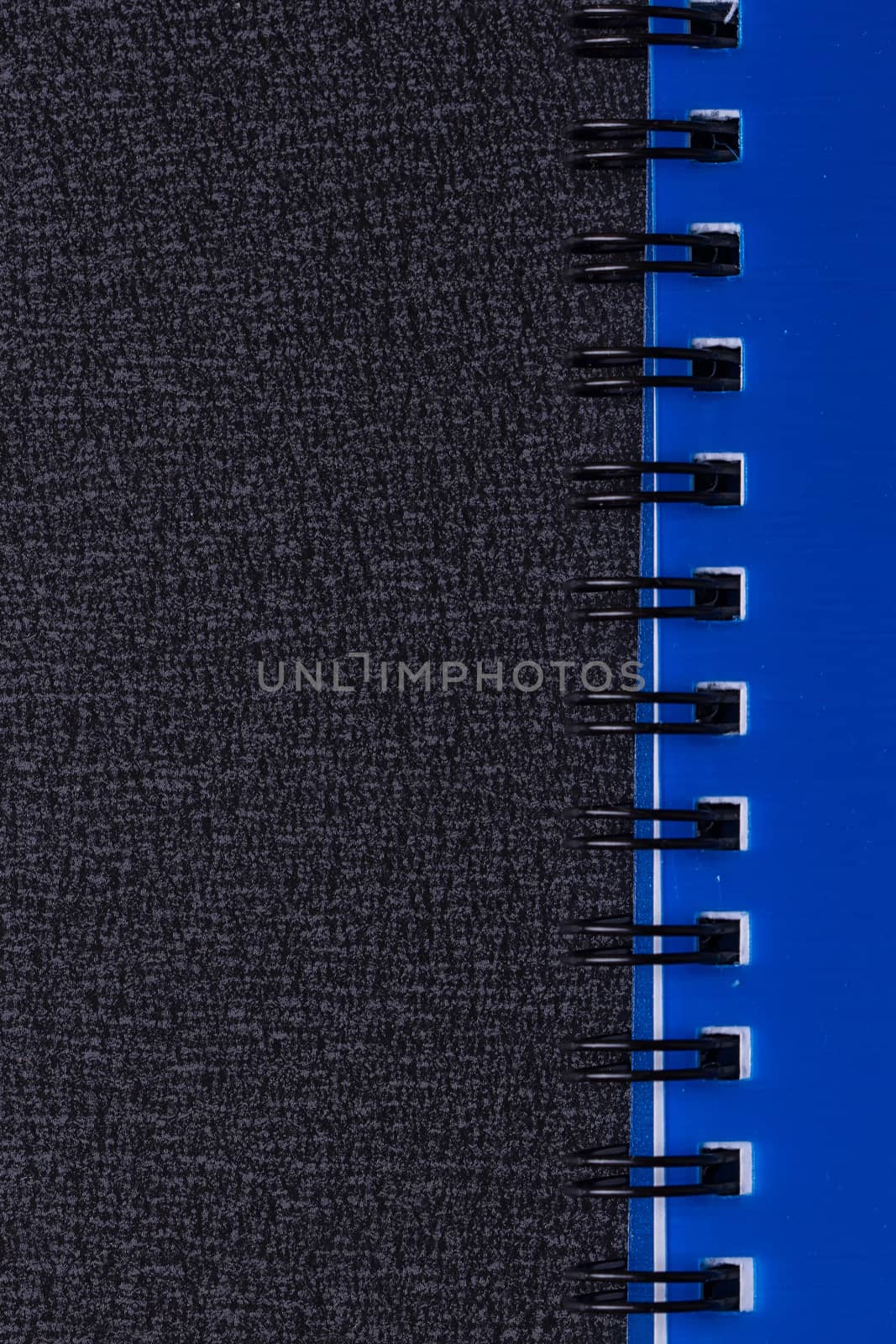 Blue notepad on a spiral on a black background