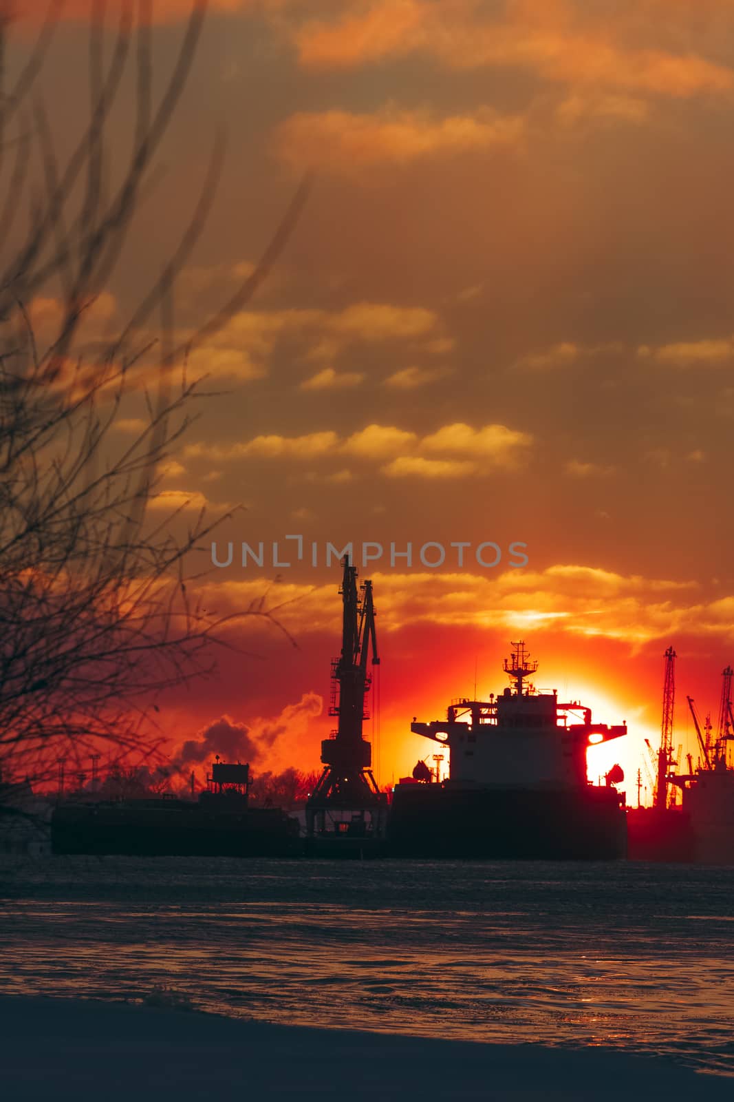 Colorful winter sunrise against the cargo port