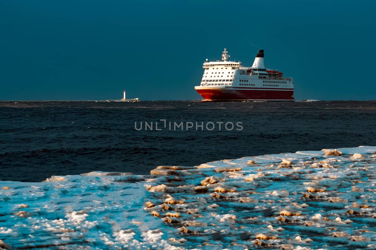 Red cruise liner. Passenger ship sailing from the sea in the morning