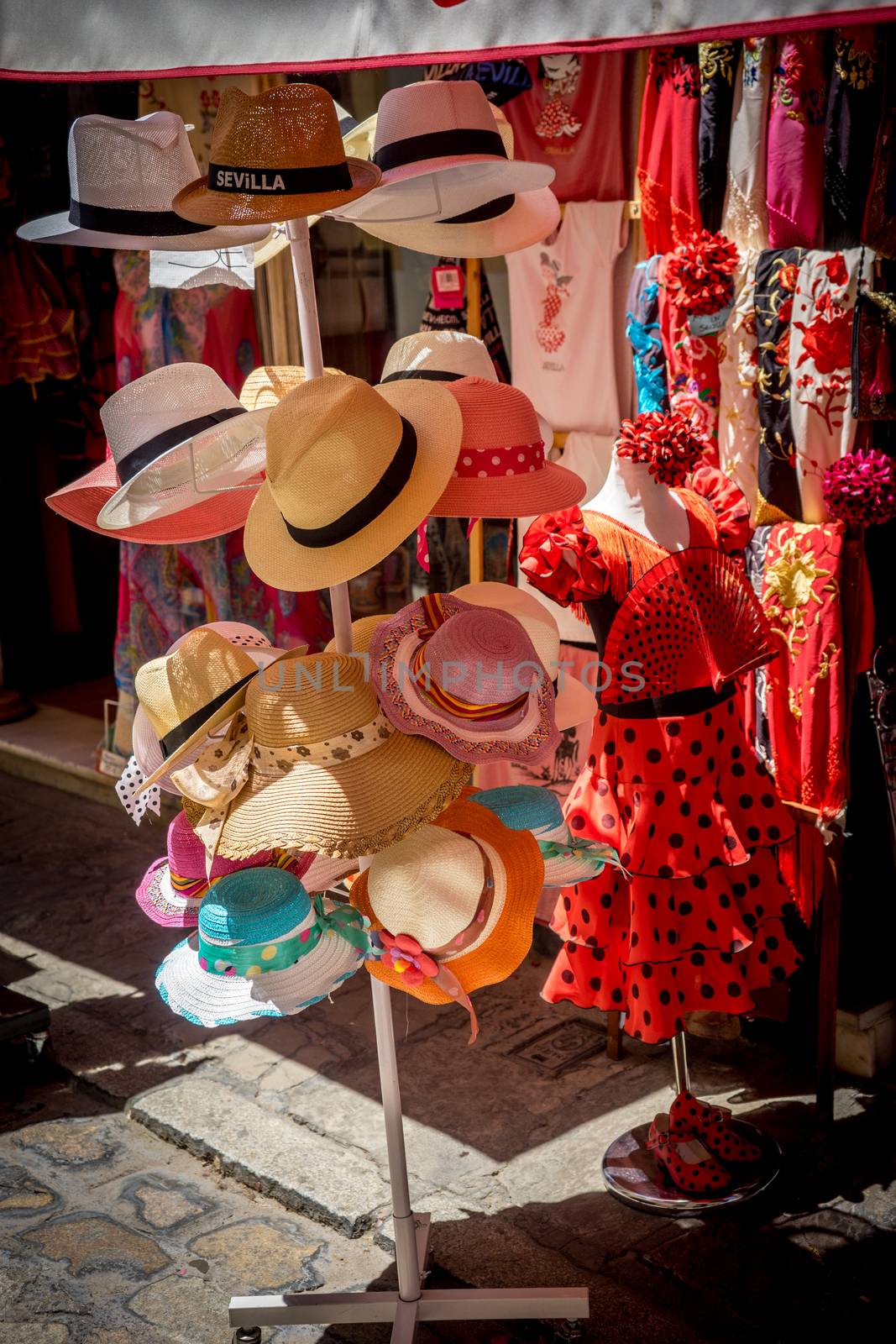 Caps and flamenco dress for sale in a shop in Seville, Spain, Europe