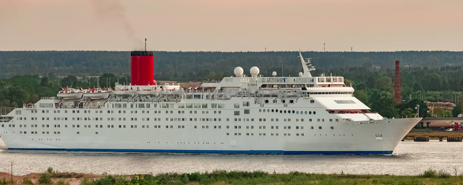 White passenger ship. Cruize ferry sailing past old town