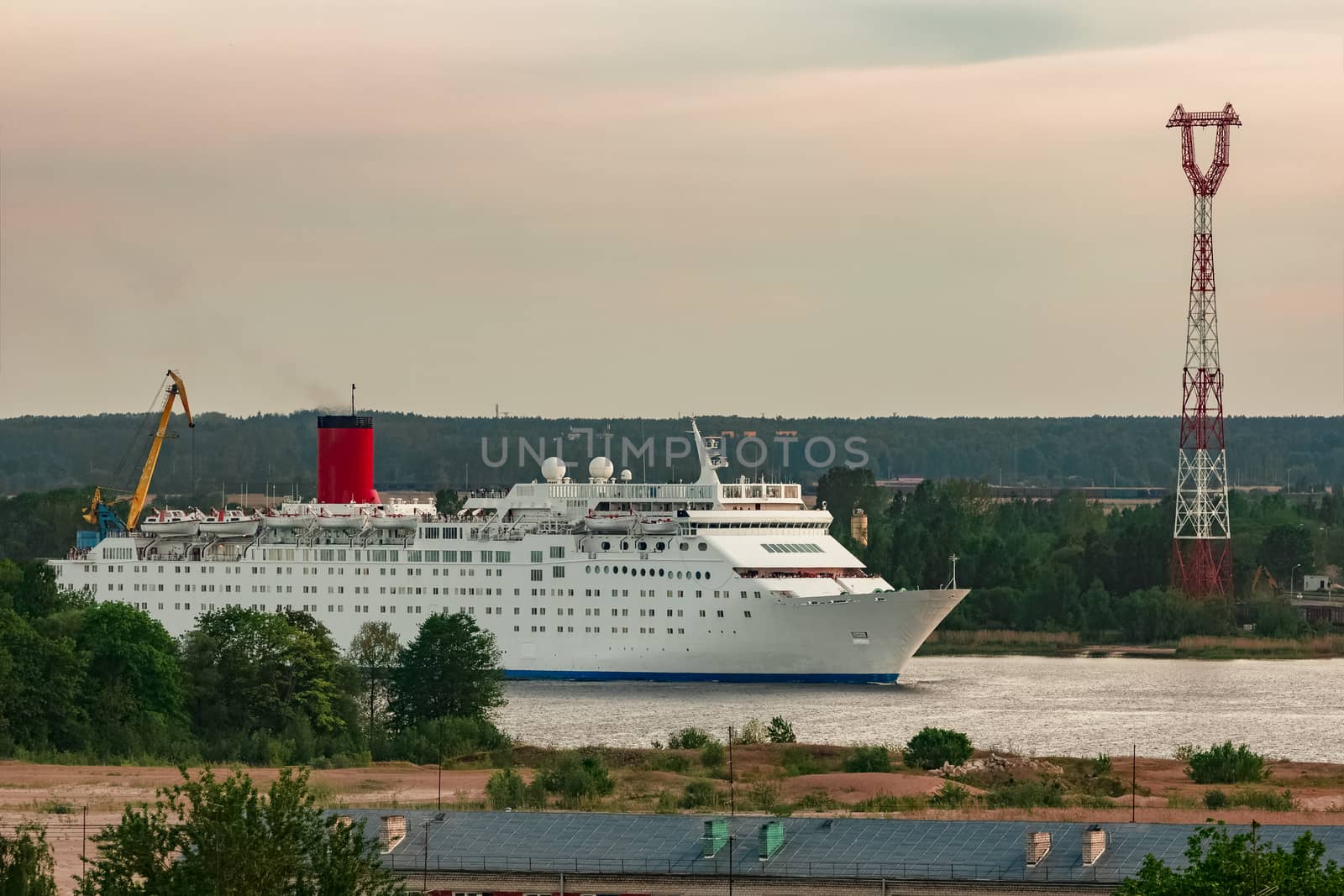 White passenger ship. Cruize ferry sailing past old town