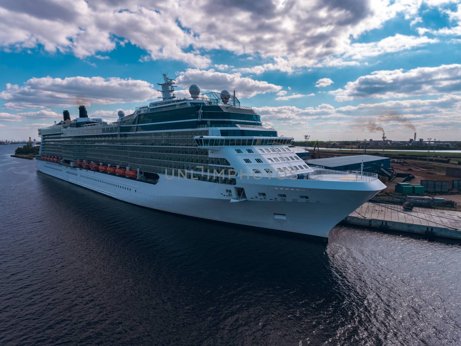Big white passenger ship moored at the cargo port