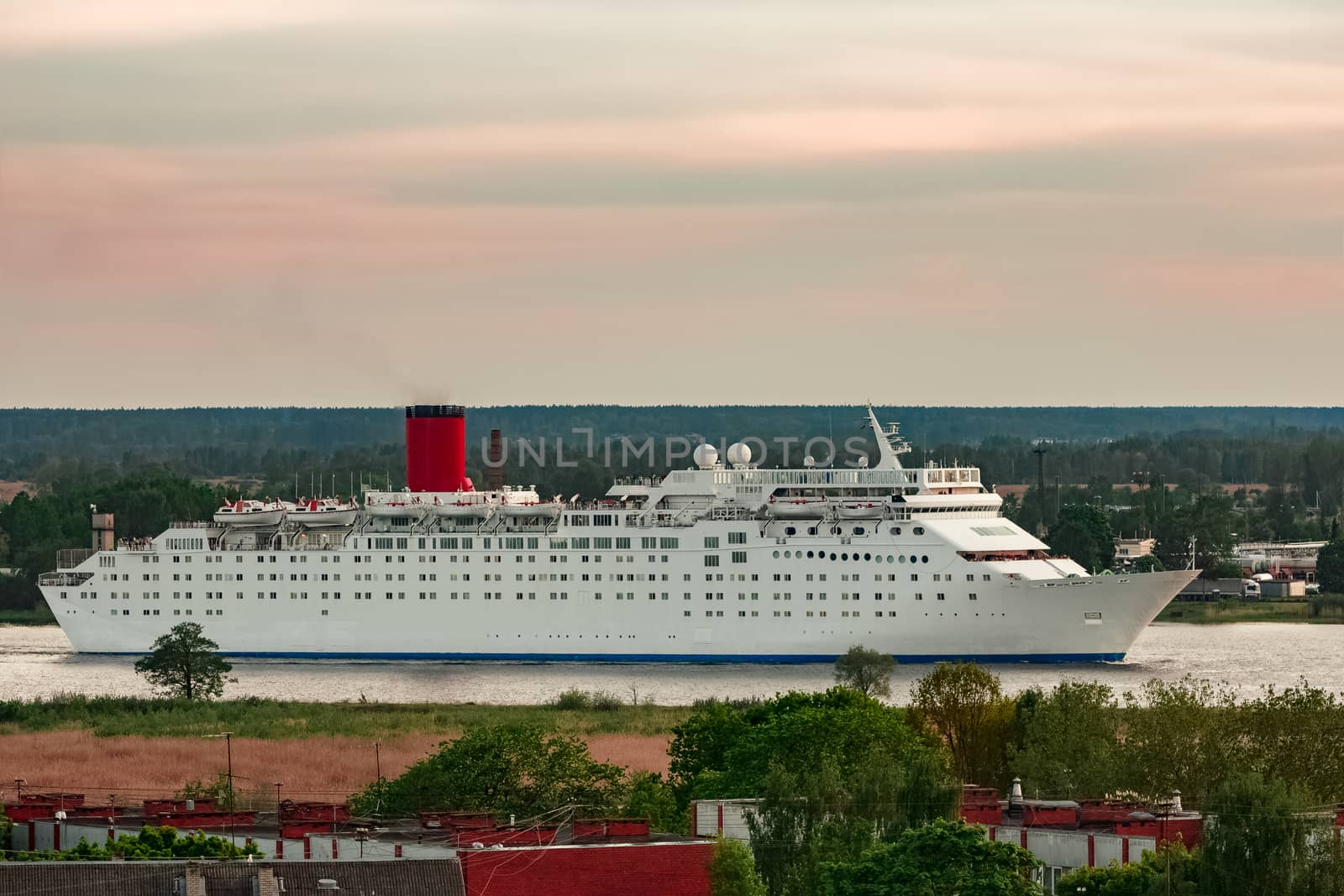 White passenger ship. Cruize ferry sailing past old town
