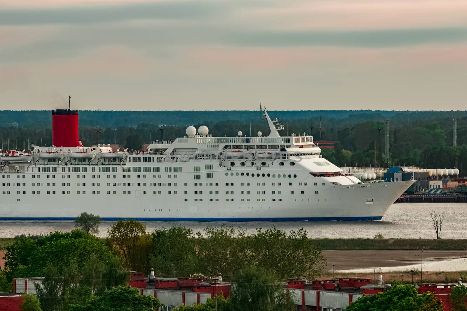 White passenger ship. Cruize ferry sailing past old town