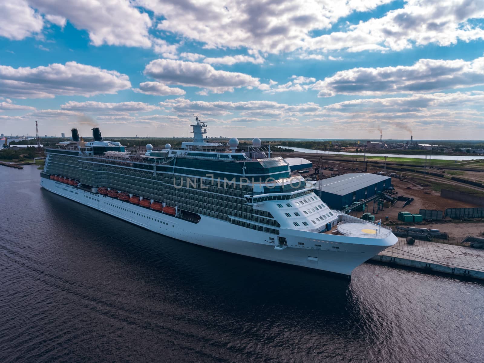 Big white passenger ship moored at the cargo port
