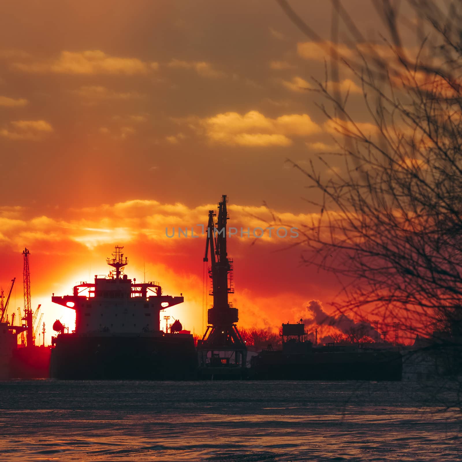 Colorful winter sunrise against the cargo port