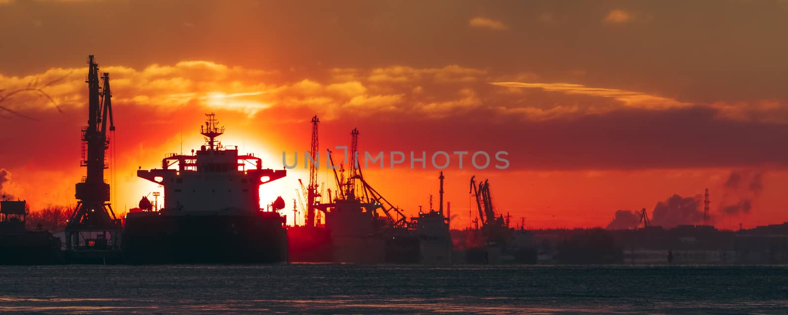 Colorful winter sunrise against the cargo port