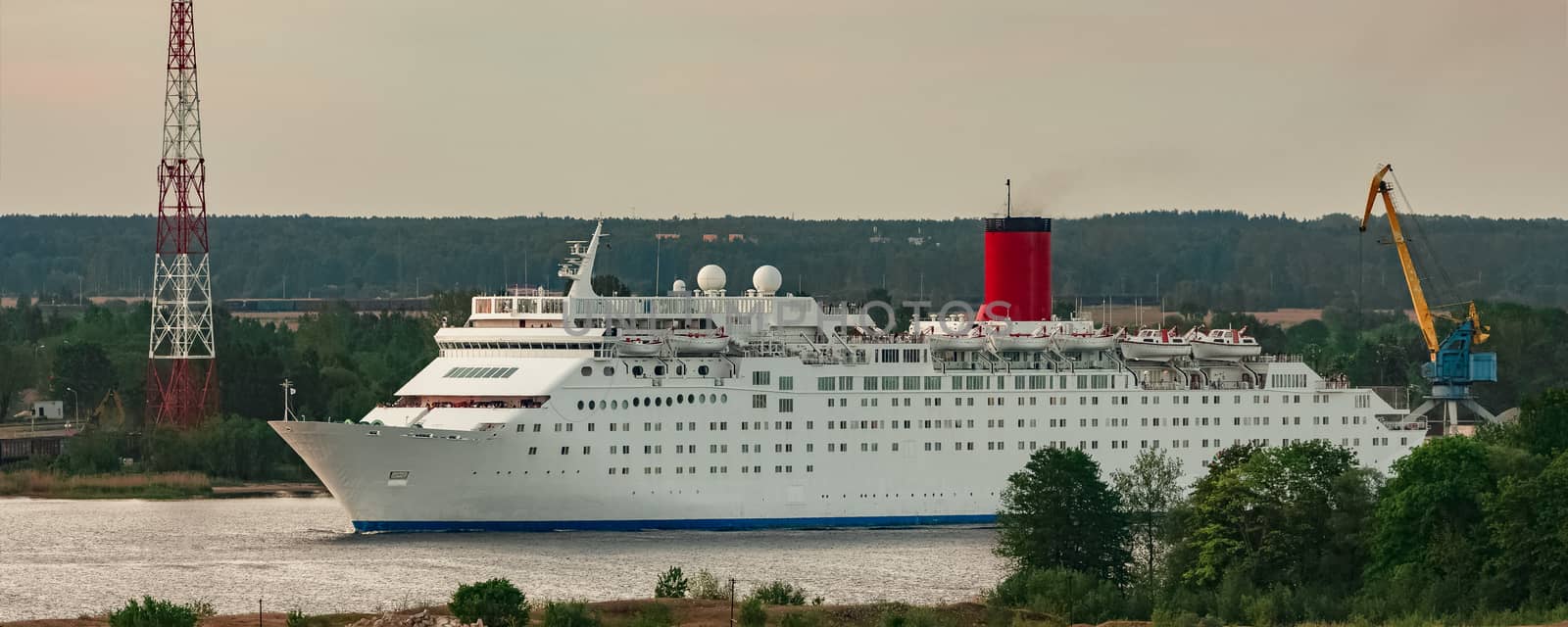 White passenger ship. Cruize ferry sailing past old town
