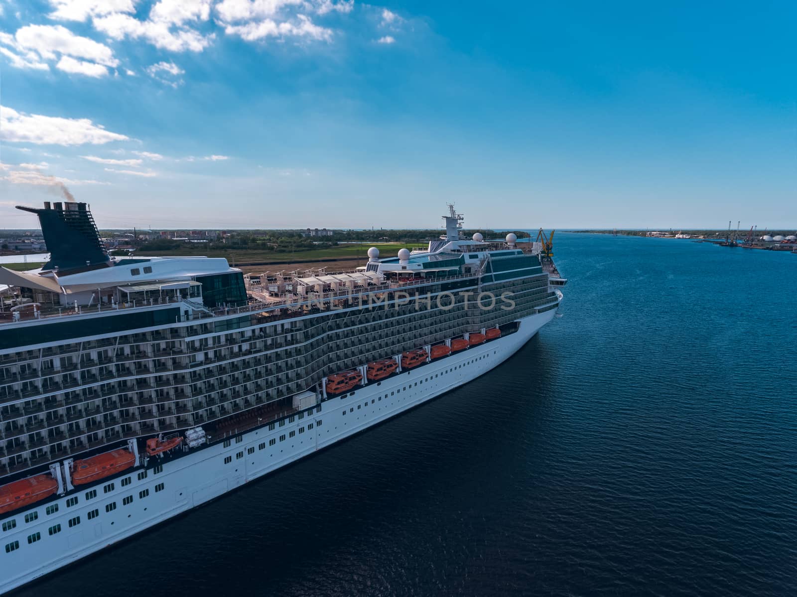 Big white passenger ship moored at the cargo port