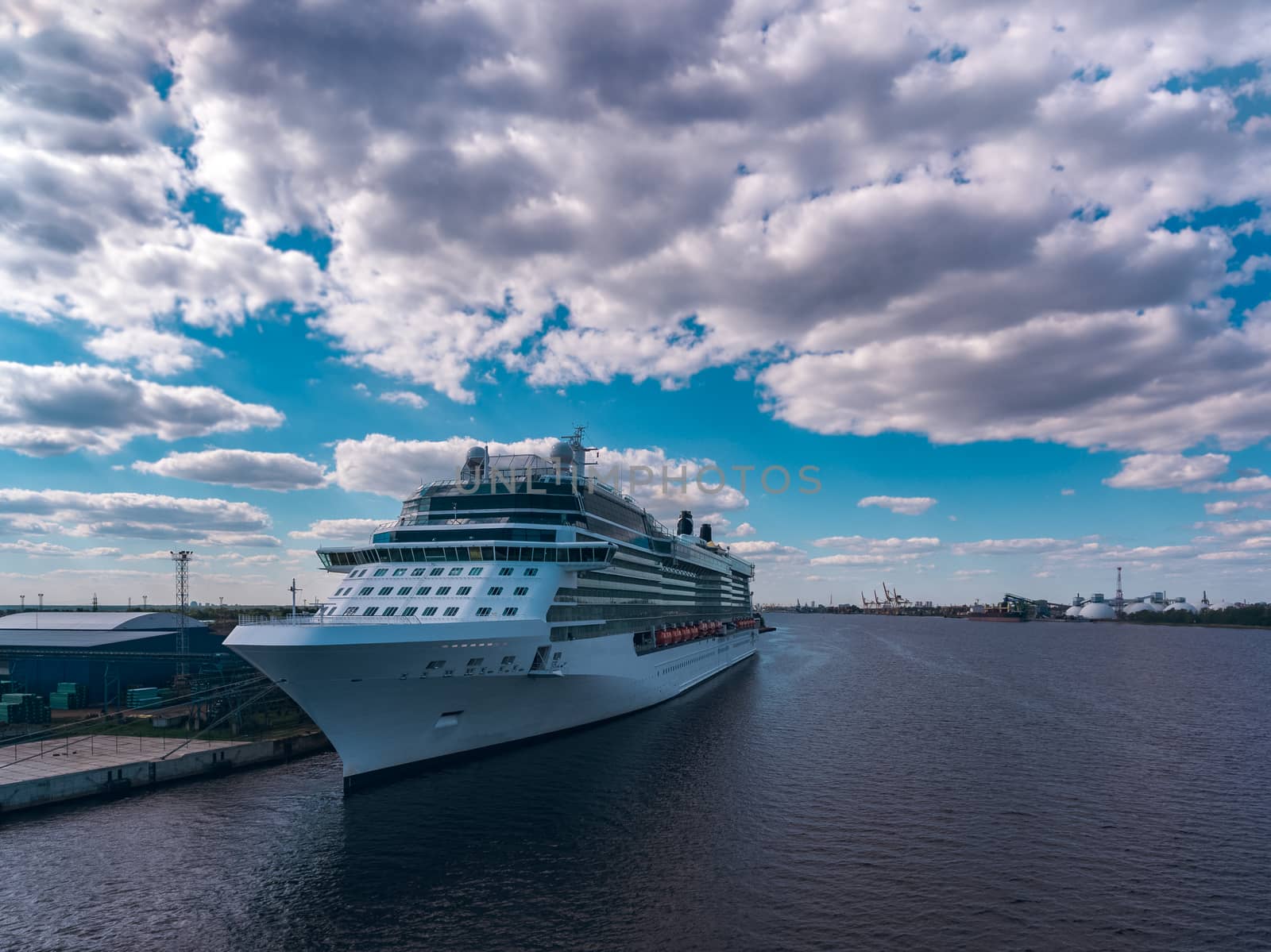 Big white passenger ship moored at the cargo port