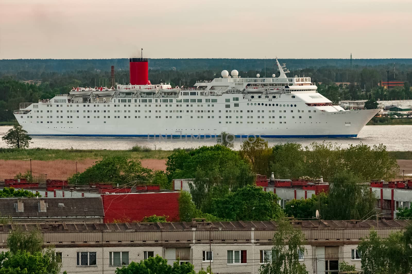 White passenger ship. Cruize ferry sailing past old town