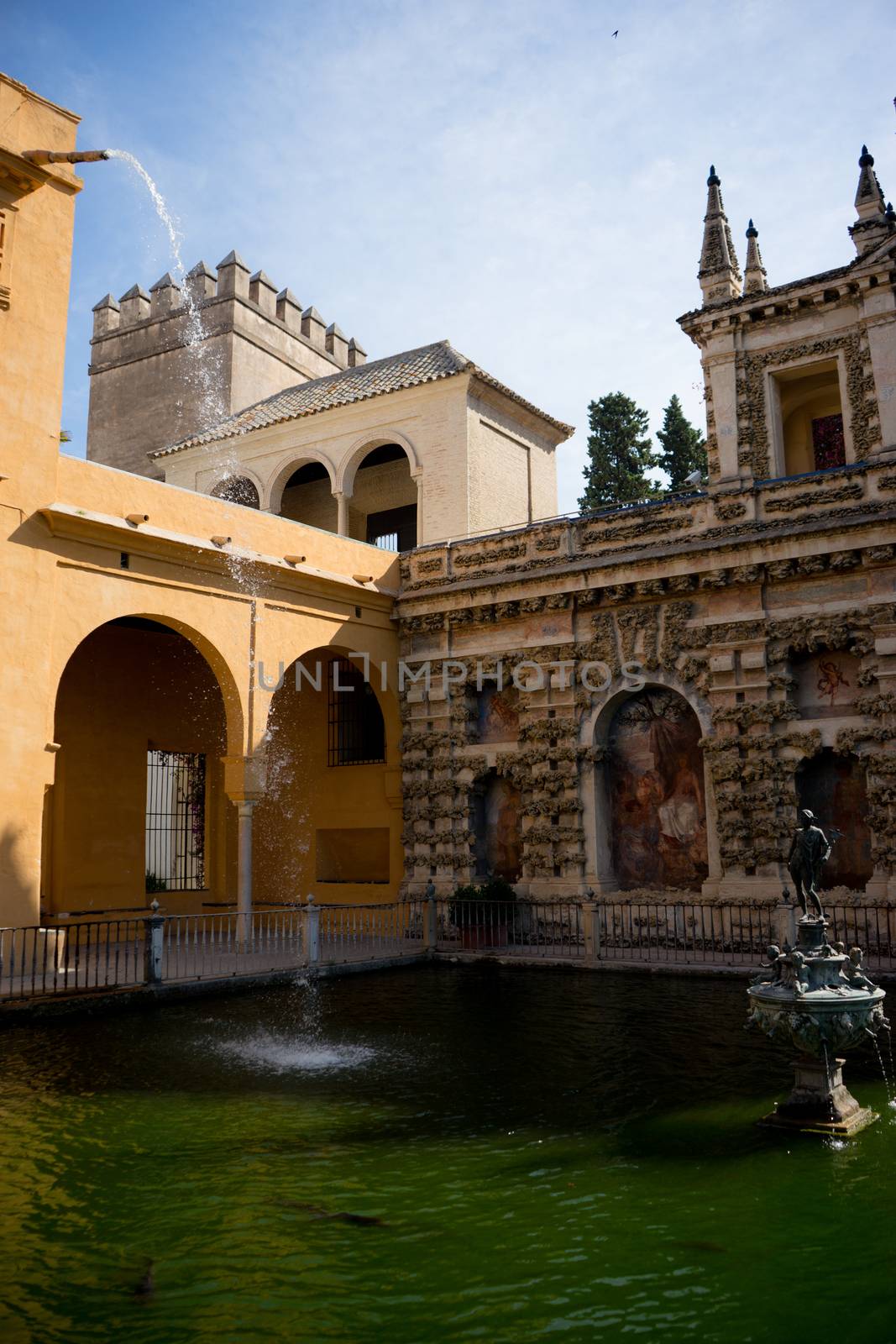 Water cascading into a pond with a Neptune statue in Seville, Sp by ramana16