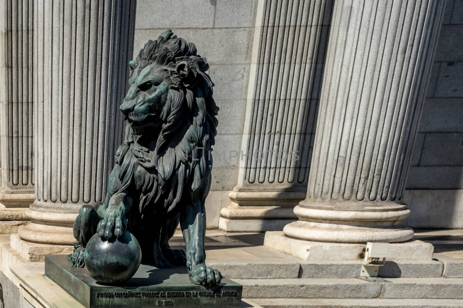 Lion sculpted out of stone in Madrid, Spain, Europe by ramana16