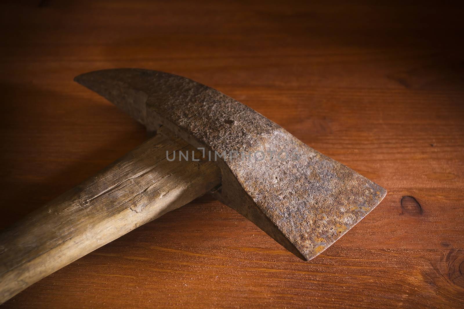 Old rusty fireman hatchet on a wooden table