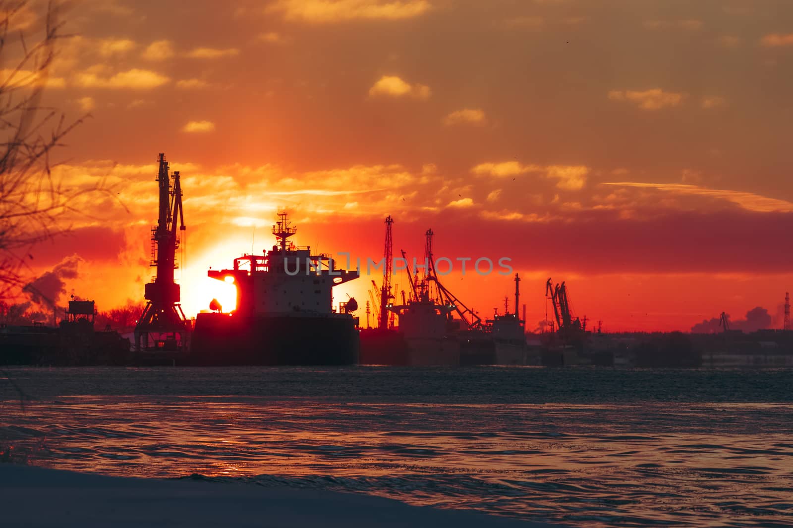 Colorful winter sunrise against the cargo port
