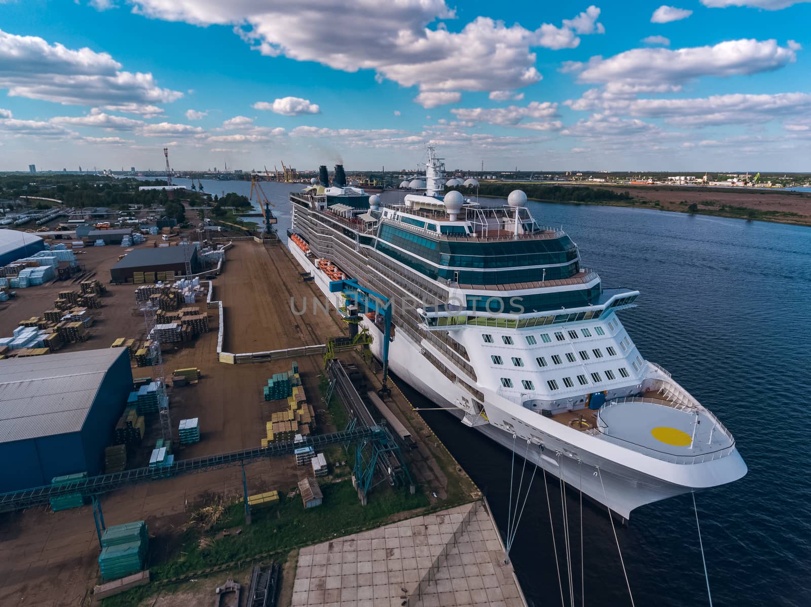 Big white passenger ship moored at the cargo port
