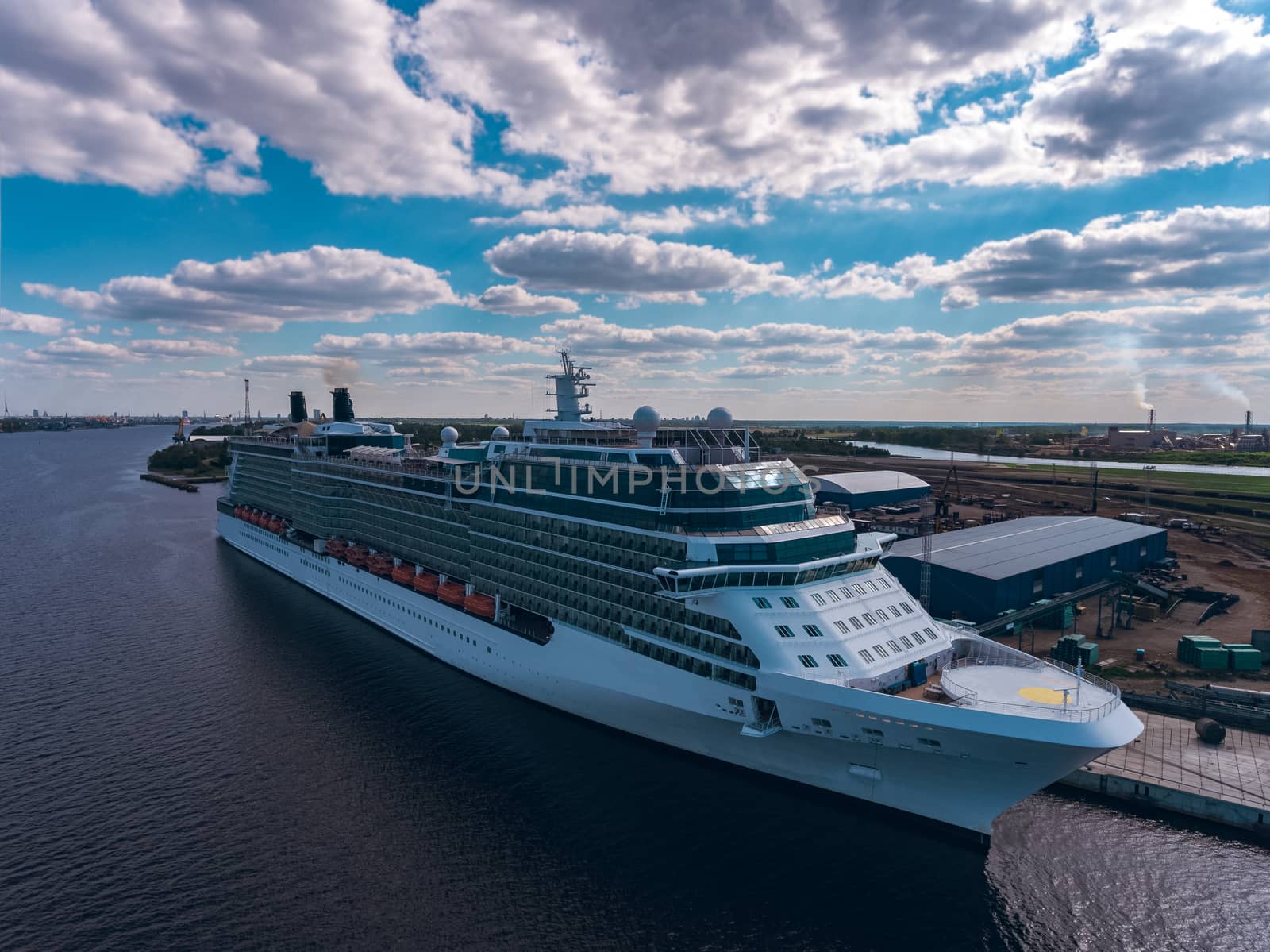 Big white passenger ship moored at the cargo port