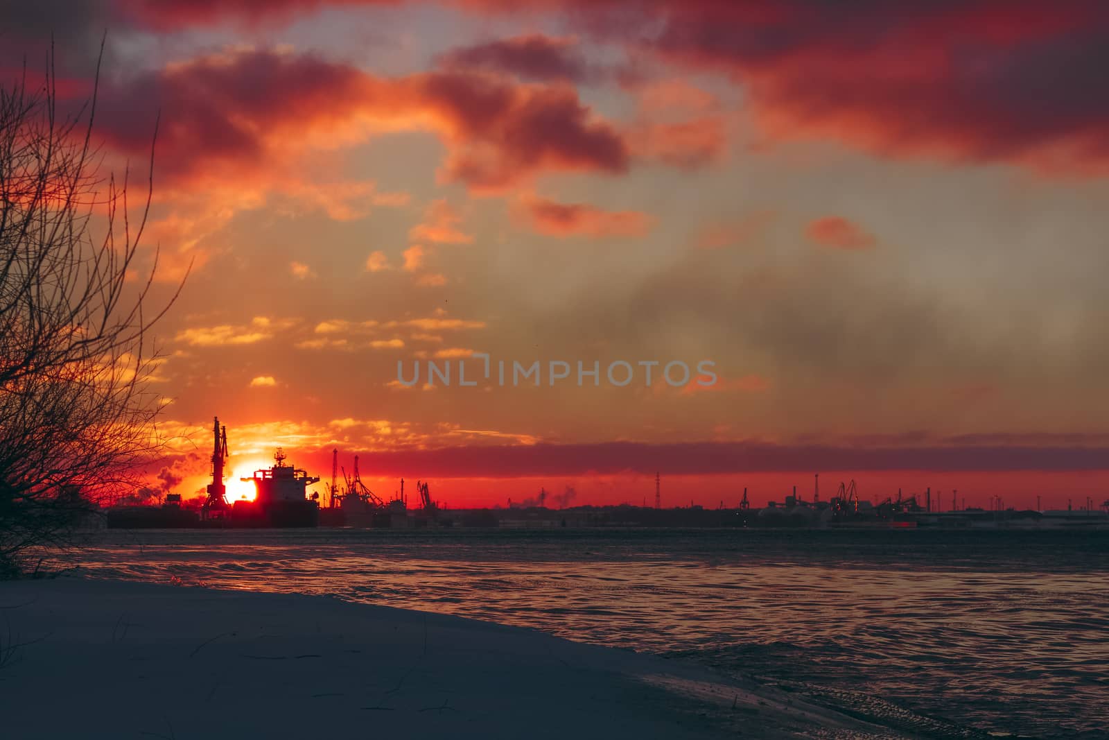 Colorful winter sunrise against the cargo port