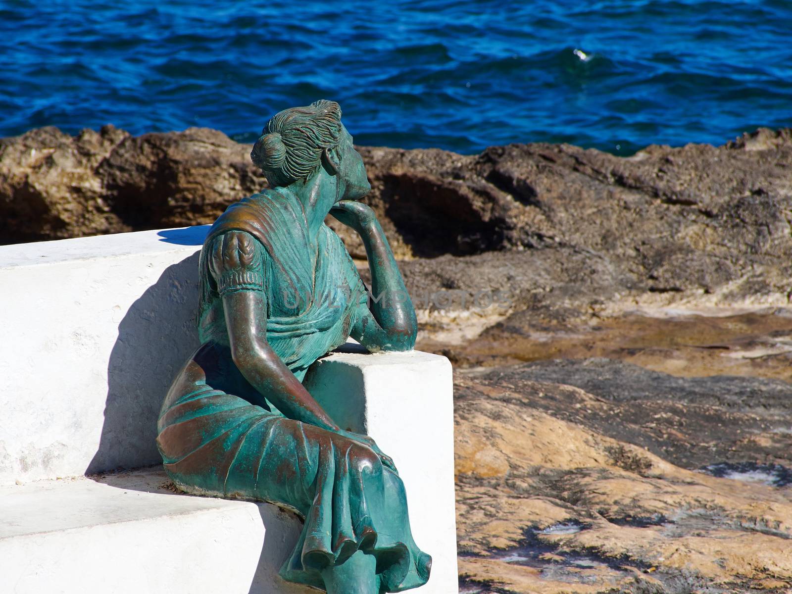 Bench made of stone in beautiful popular summer tourism destination Torrevieja beach, Costa Blanca, Valencia, Spain