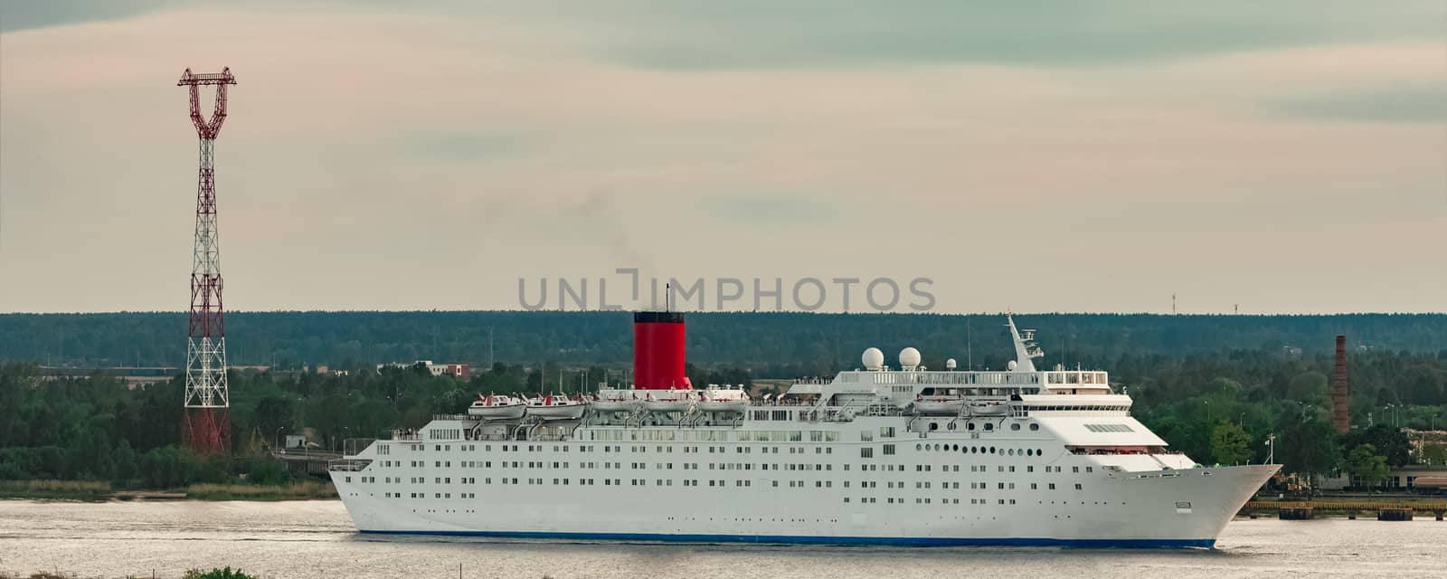 White passenger ship. Cruize ferry sailing past old town