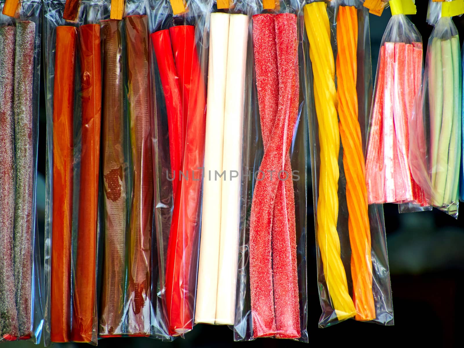 Soft sticks bundle colored licorice candies on display in a market shop