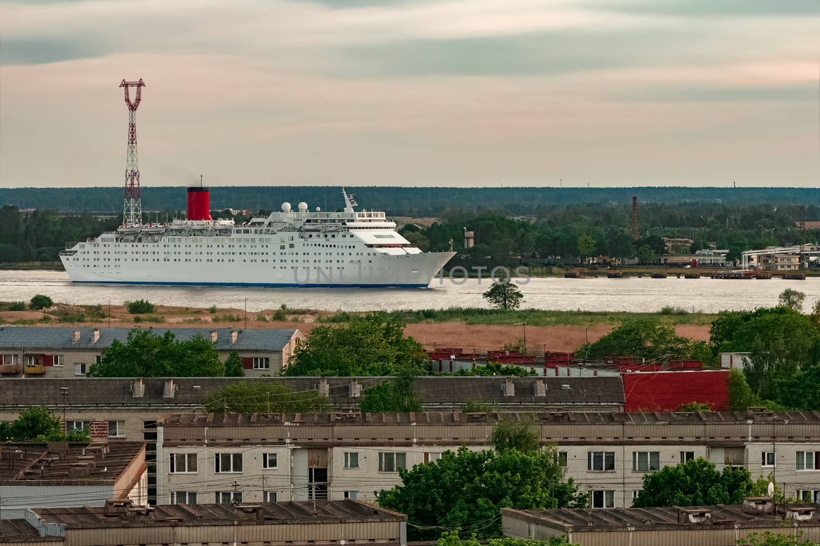 White passenger ship. Cruize ferry sailing past old town