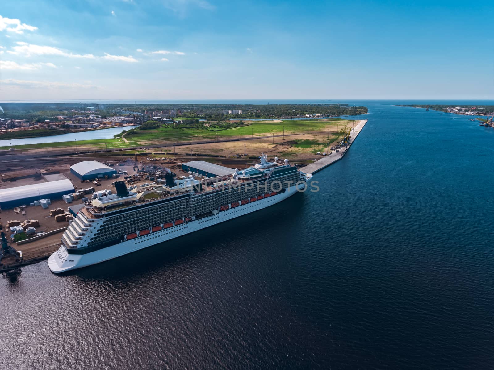 Big white passenger ship moored at the cargo port
