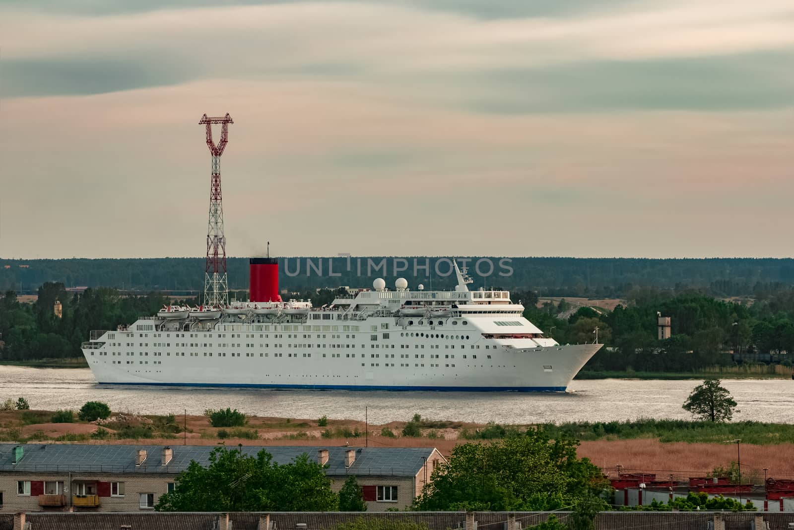 White passenger ship. Cruize ferry sailing past old town