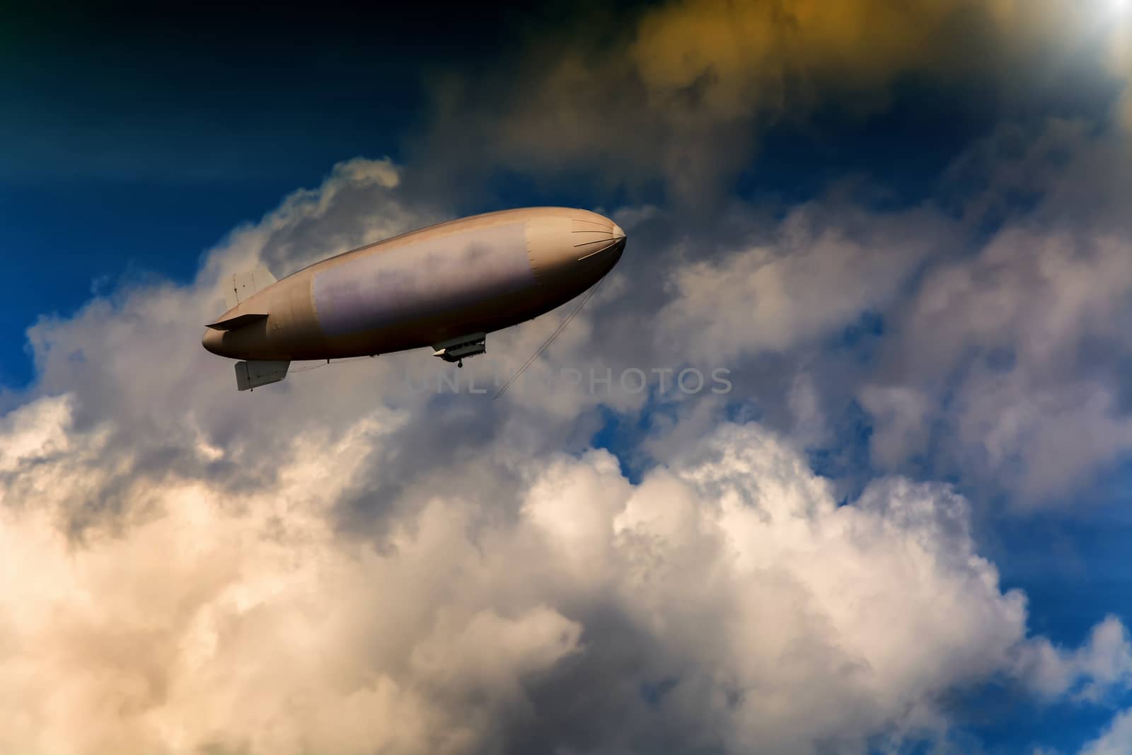 Airship, zeppelin against blue sky with dark clouds.