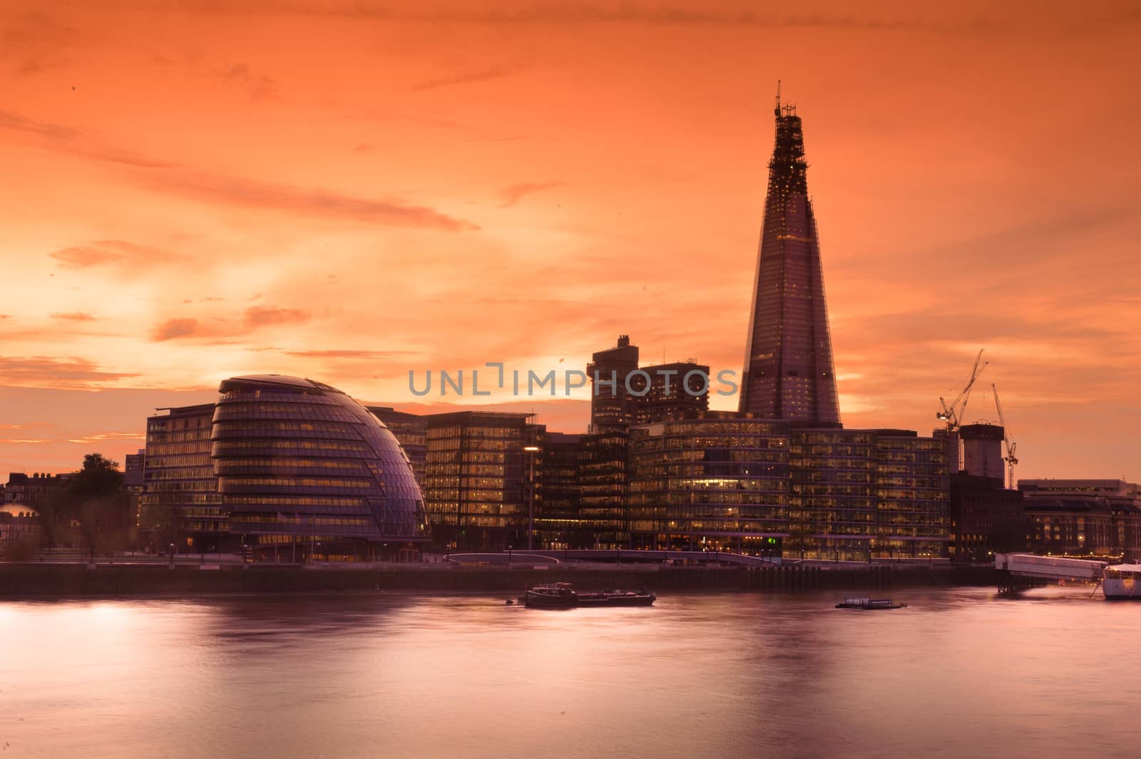 The bank district of central London with famous skyscrapers and other landmarks at sunset with blue sky - London, UK