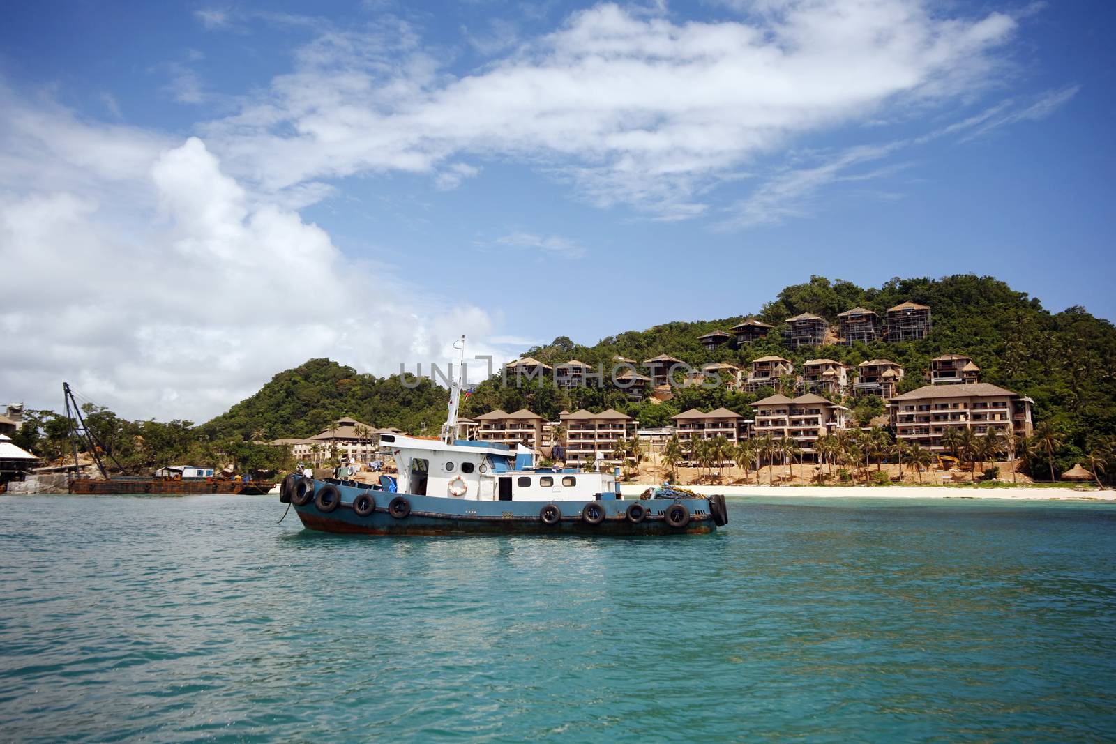 An old fishing boat on the background of the island of Boracay