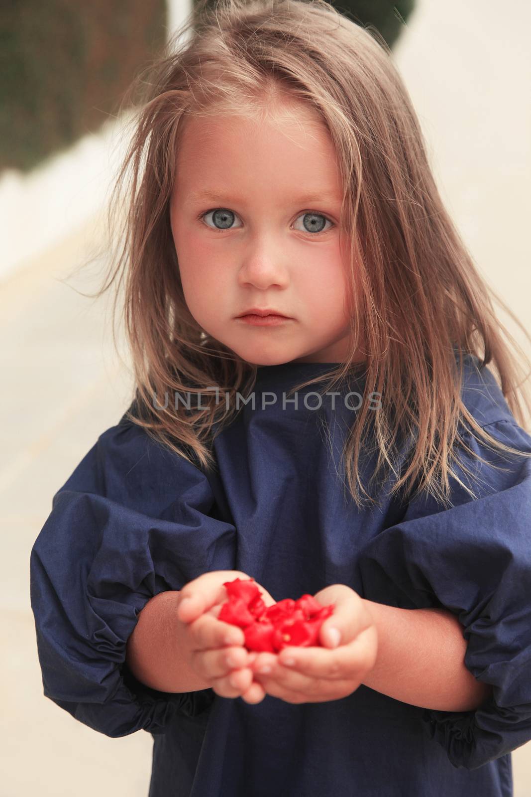 Little girl laughing on street