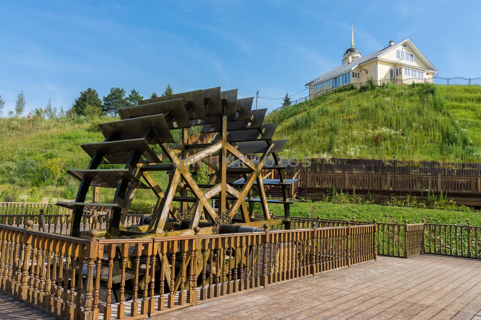 Water mill on the background of the church, Radonezh, Russia, Golden Ring, summer