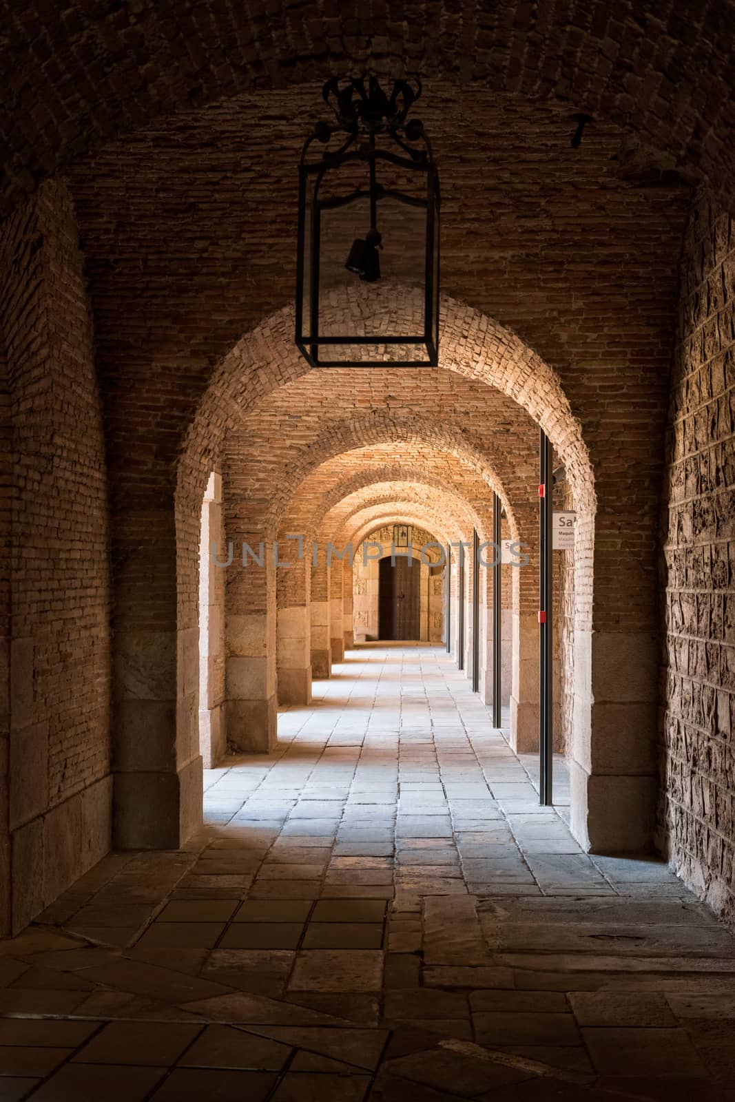Barcelona, Spain - September 25, 2015: View of cloister inside Barcelona Montjuic castle. Copy space on black ceiling.