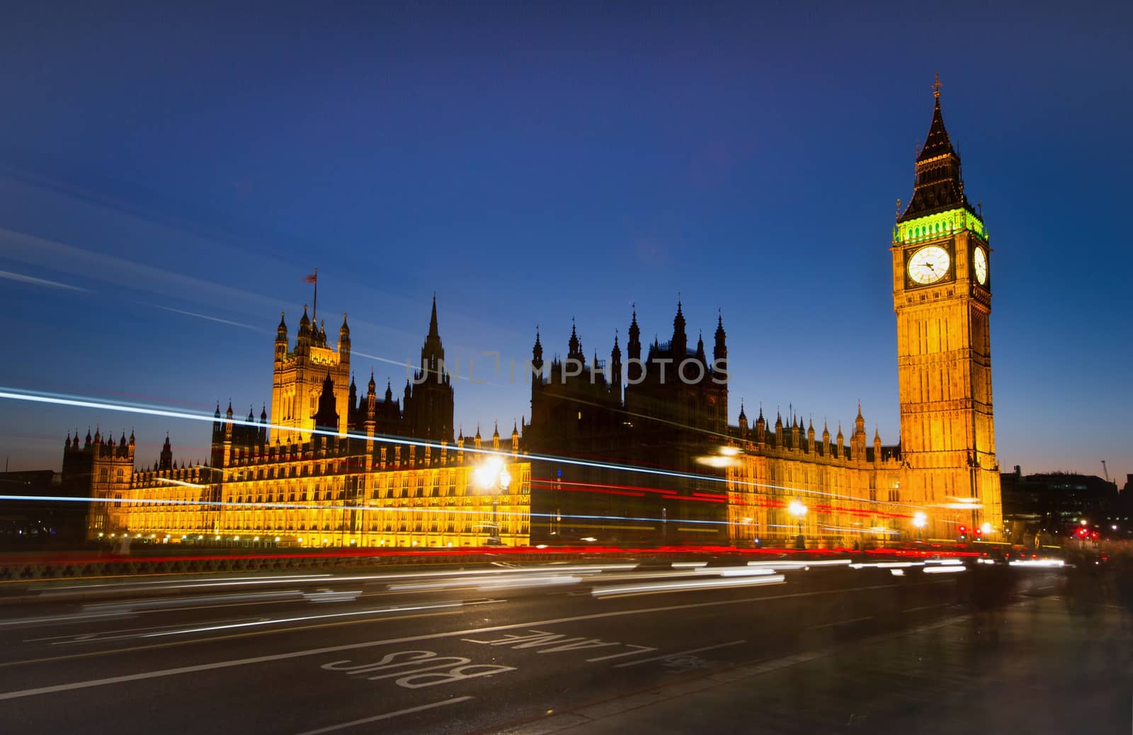 Big Ben and London at night with the lights of the cars passing by after rain, the most prominent symbols of both London and England
