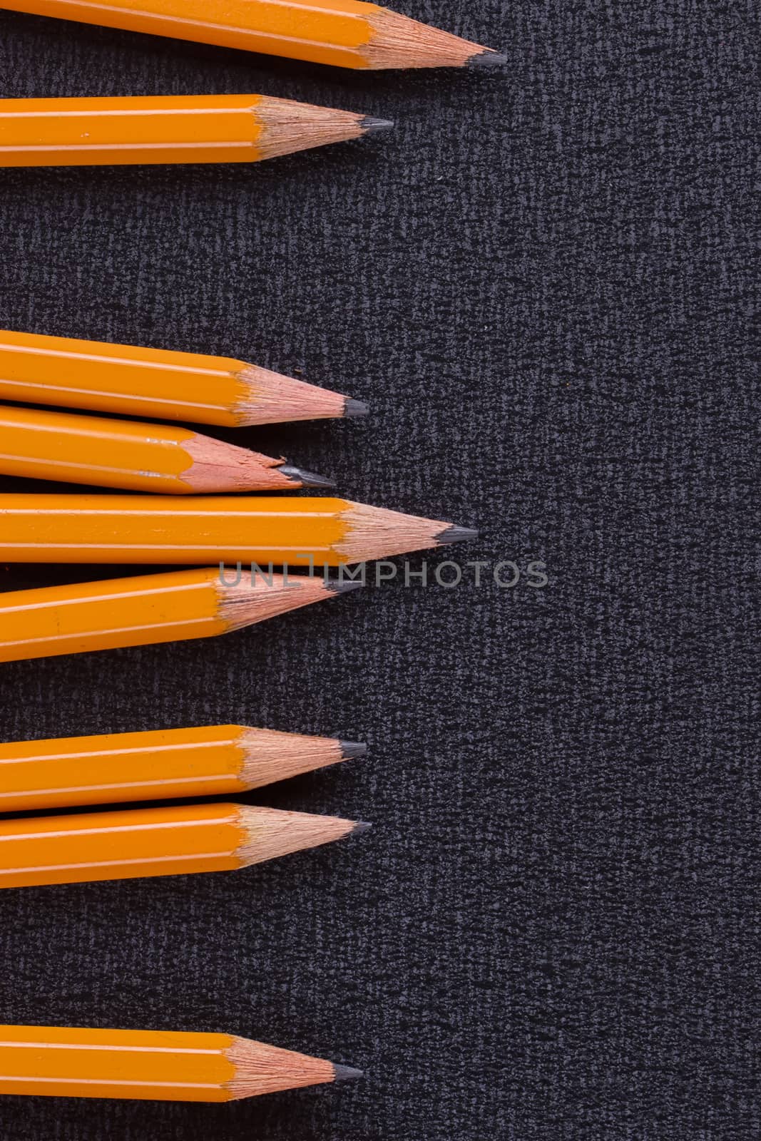 set of pencils on black background, closeup, macro