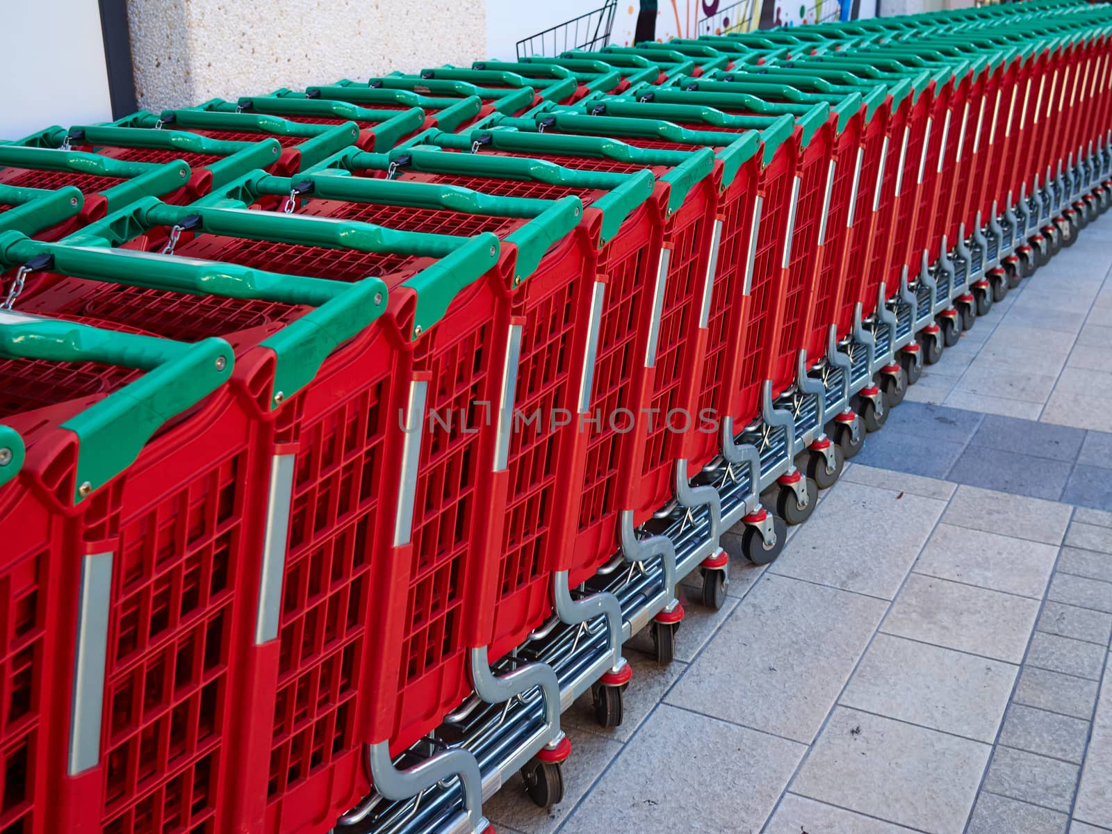 Line of supermarket shopping cart trolley to be filled with food products groceries